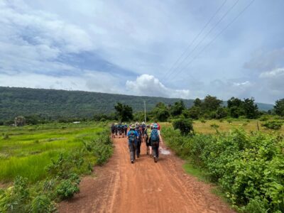 Group of travellers walking on a path in cambodia