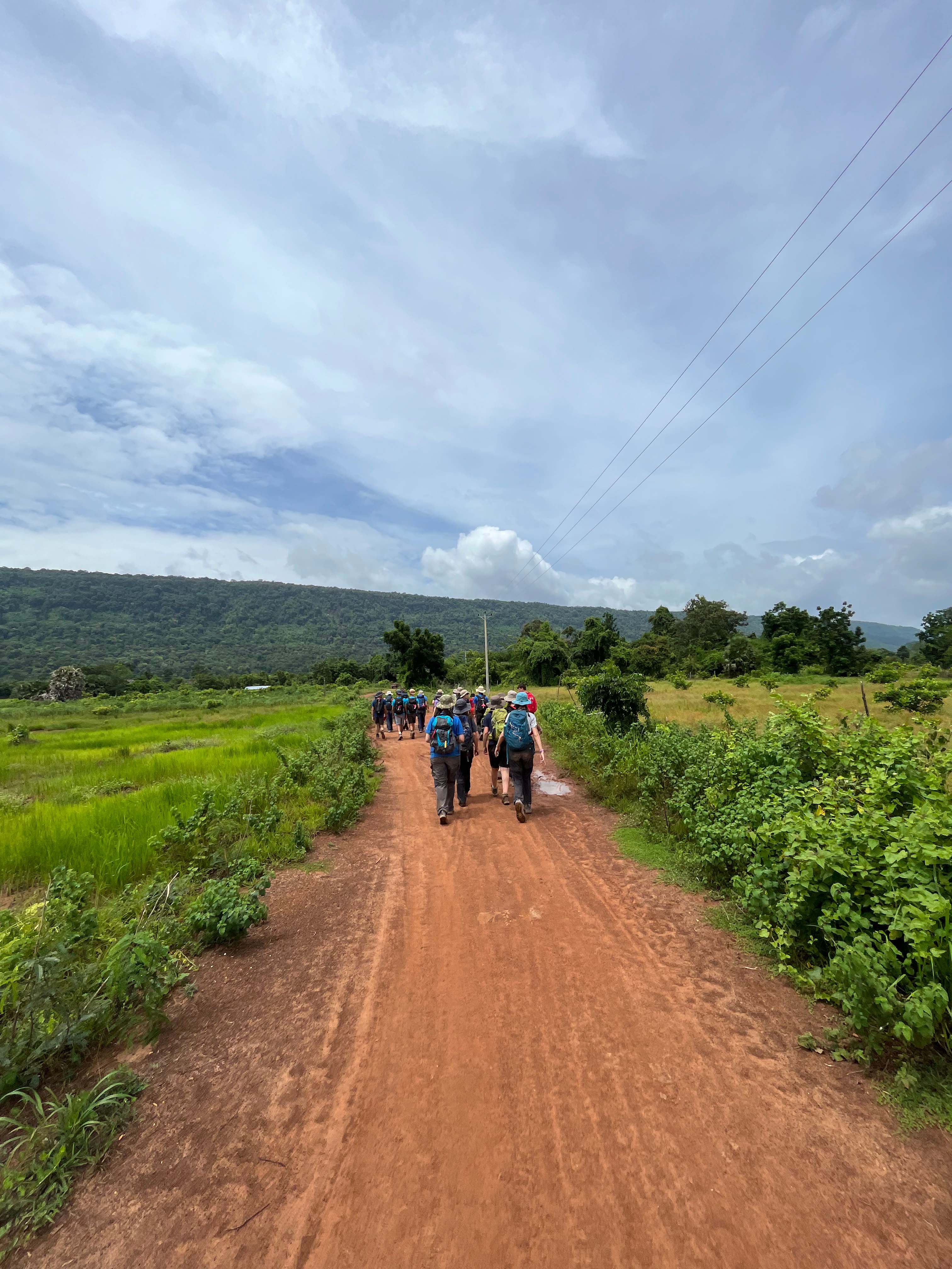 Group of travellers walking on a path in cambodia
