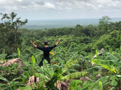 A traveller enjoying beautiful views on a trek in Cambodia