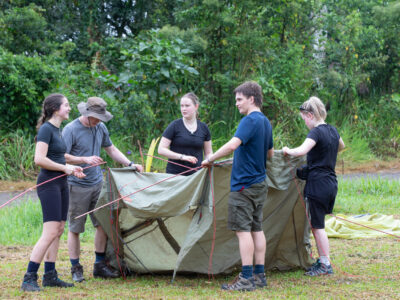 Travellers putting up a tent, Costa Rica