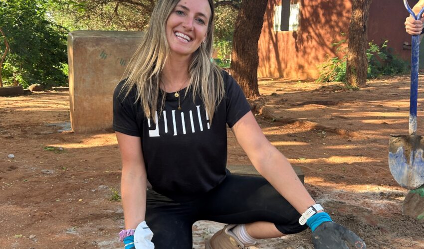 Yoga teacher Liv building bricks whilst on Project Work.