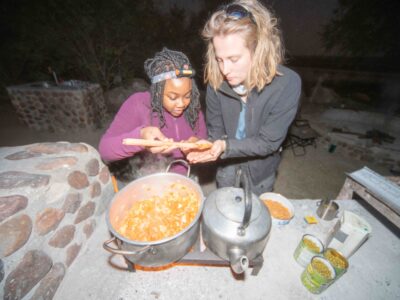 Two travellers cooking in camp, South Africa