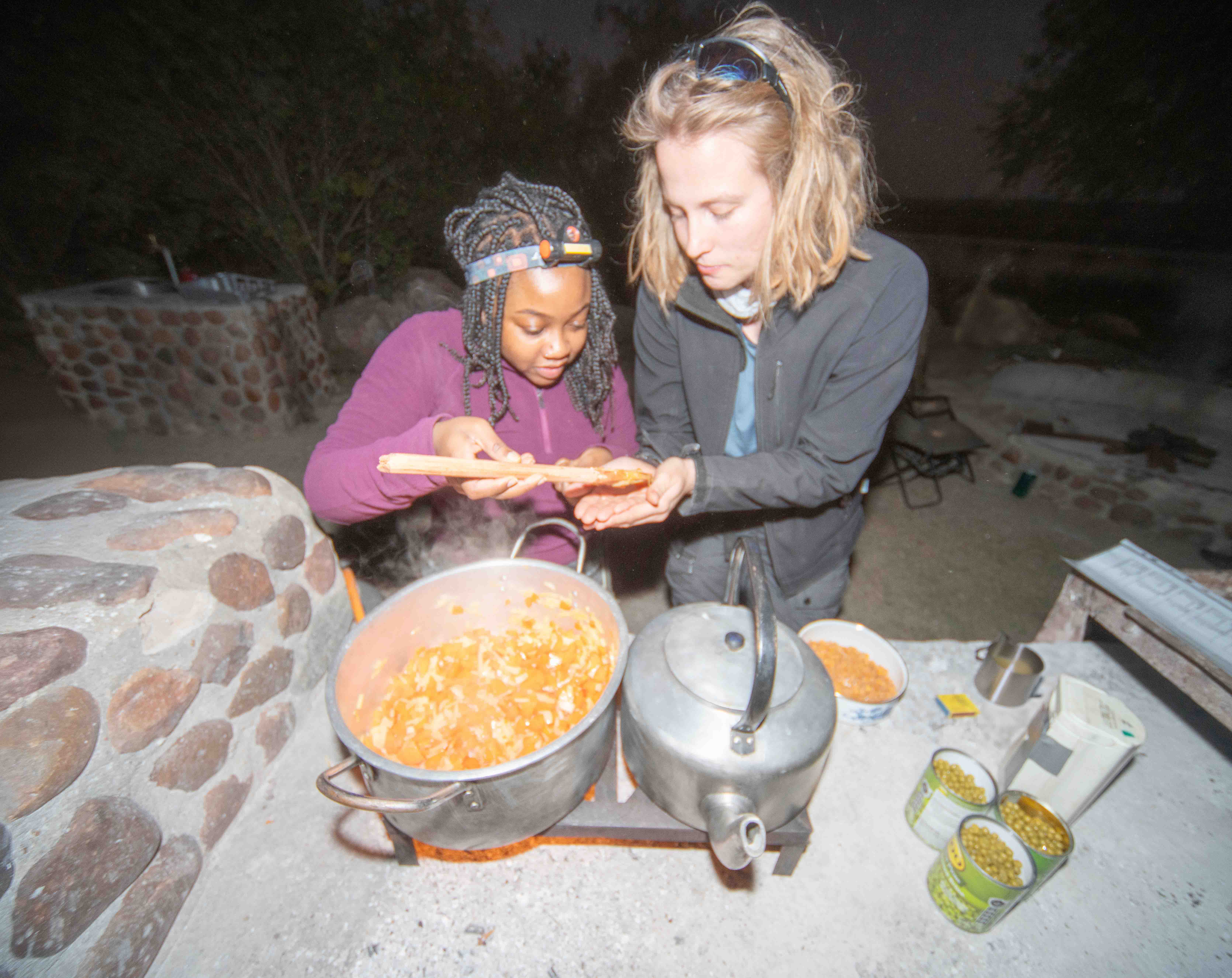 Two travellers cooking in camp, South Africa