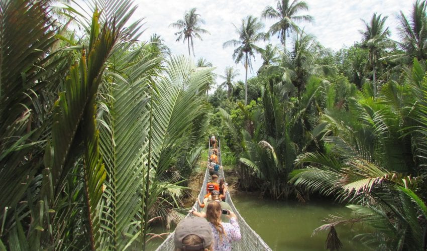 School expedition in Borneo - travellers crossing a bridge