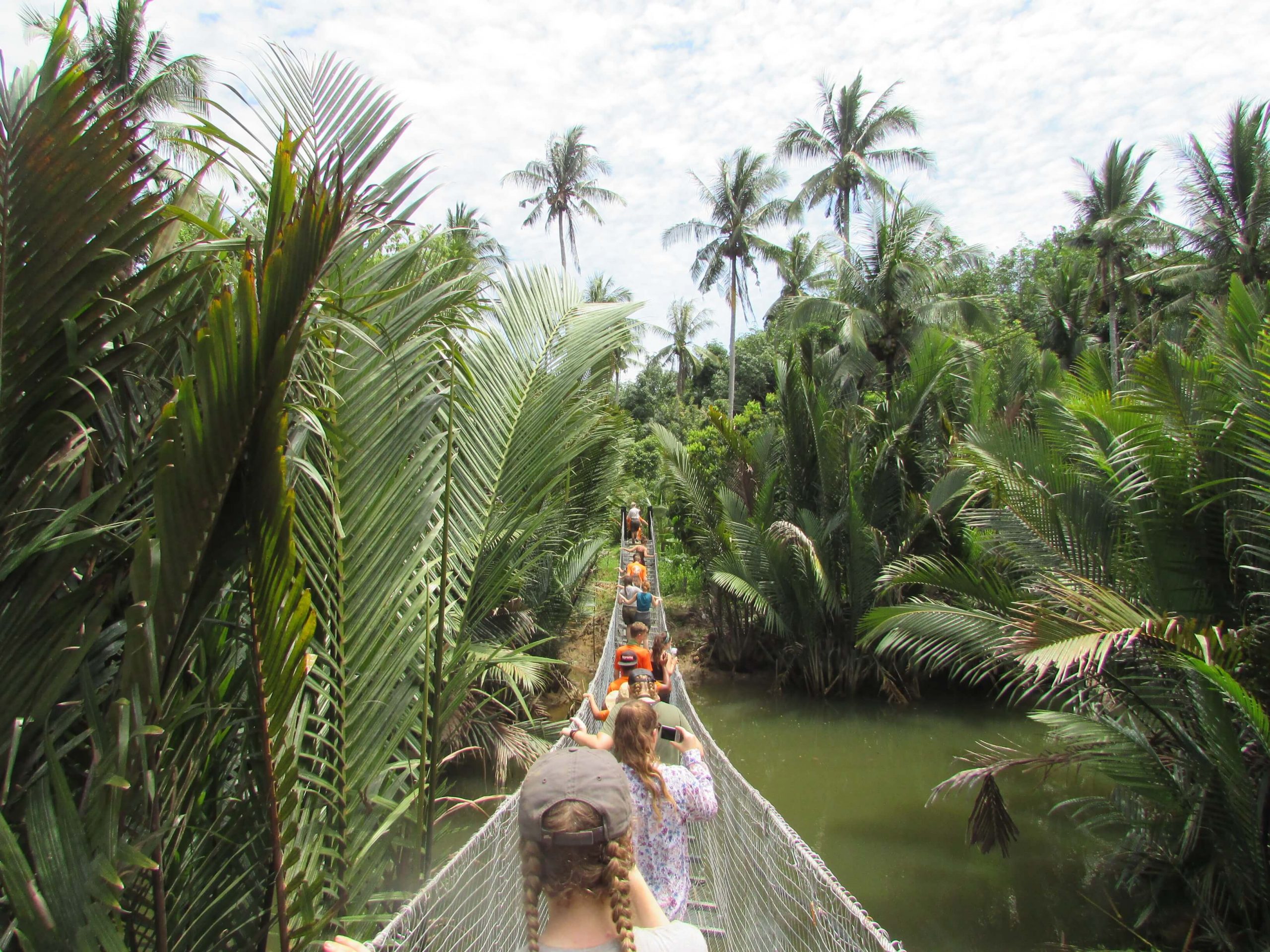 School expedition in Borneo - travellers crossing a bridge