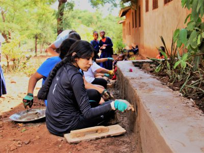 school_expedition_tanzania_trek_plastering_wall